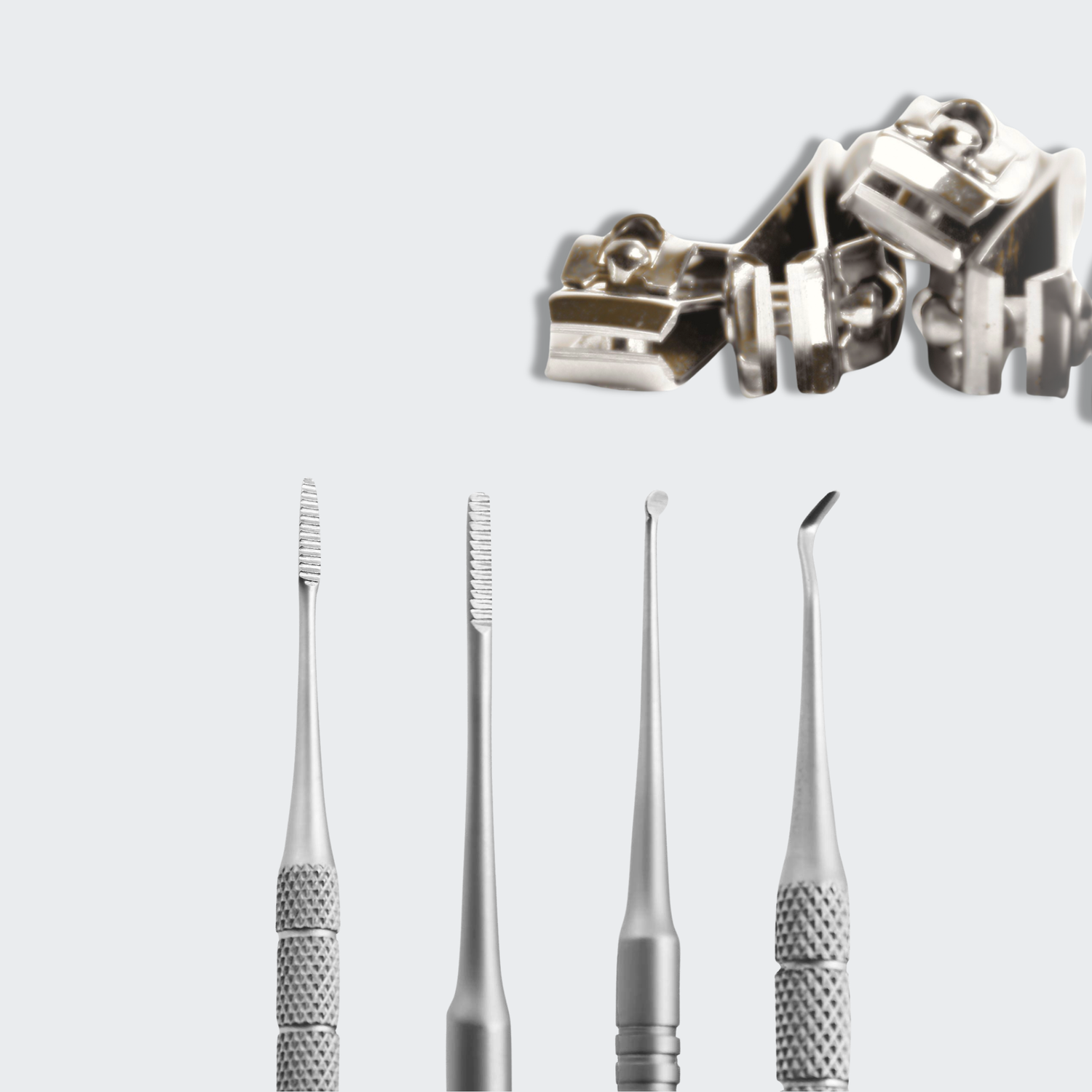 Set of dental tools including probes and curettes on a light gray background