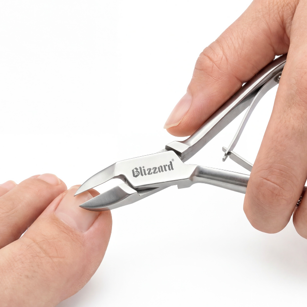 Hand holding a pair of Blizzard brand nail clippers on a white background