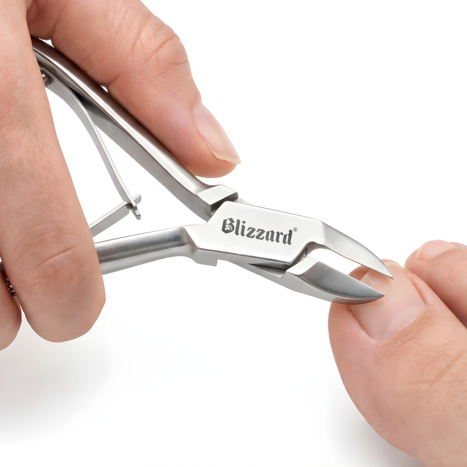 Metallic fruit peeler with 'Blizzard' branding held by a hand on a white background